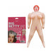 Inflatable party doll Big Betty with red hair and exaggerated features next to its pink packaging box.