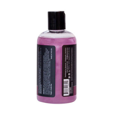 Back view of Big Flirt Pheromone Infused Bubble Bath bottle with purple liquid and black cap