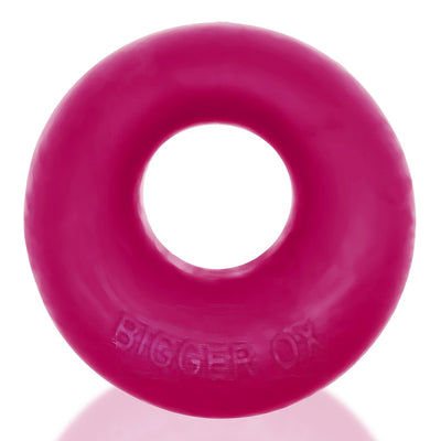 Bright pink thick silicone TPR cockring with embossed Bigger Ox branding, smooth and rounded design.