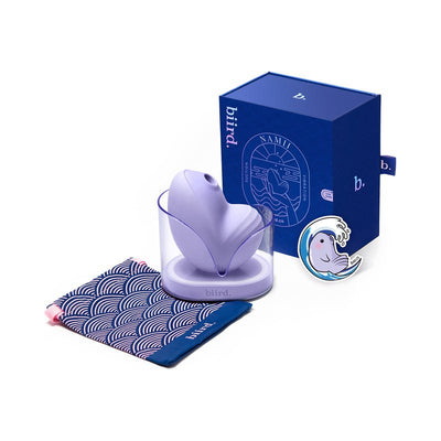 Biird Namii clitoral stimulator in lavender with charging base, patterned storage pouch, and blue product box.