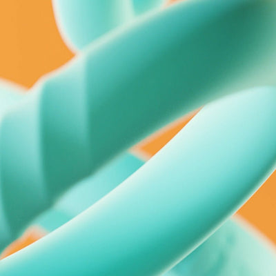 Close-up of three mint-colored silicone C-rings with smooth and textured surfaces against an orange background.