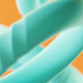 Close-up of three mint-colored silicone C-rings with smooth and textured surfaces against an orange background.
