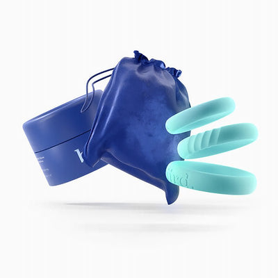 Three mint-colored silicone rings with a blue storage pouch and container on a white background.