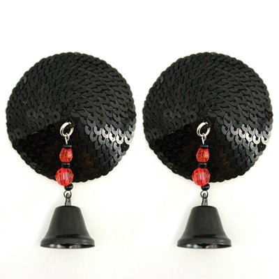 Pair of round black sequin pasties with dangling black bells and red bead accents on white background.
