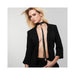 Woman wearing a black vegan leather tassel choker from Bijoux Indiscrets Maze Collection with a black blazer and pants.