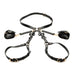 Black adjustable PU leather thigh and wrist bondage harness with gold buckles and decorative bows laid flat on white background.