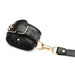 Black PU leather wrist cuff with gold buckle and clasp detail on white background