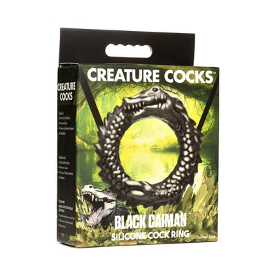 Packaging box for Black Caiman silicone cock ring featuring a black caiman design against a swampy green background.