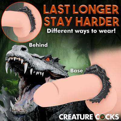 Black silicone cock ring shaped like a smiling caiman, shown worn at the base and behind the shaft for longer-lasting firmness.