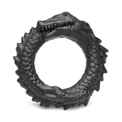 Black silicone cock ring shaped like a coiled caiman with textured scales and a grinning face.