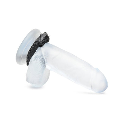 Clear silicone dildo with a black caiman-shaped cock ring featuring textured ridges and a grinning face.