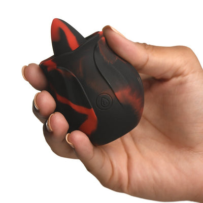 Hand holding a black and red silicone rose-shaped personal massager with a textured tongue detail and power button.