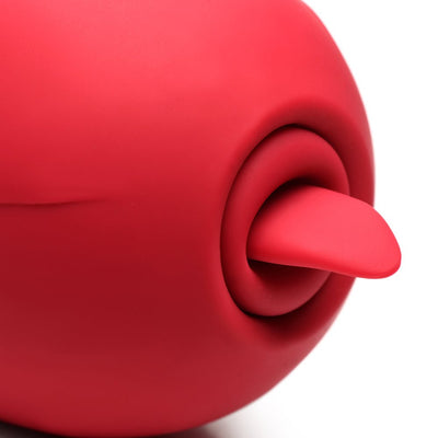 Close-up of red silicone pleasure toy with soft tongue detail emerging from circular opening.