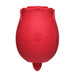 Compact red rose-shaped silicone personal massager with a single button and a small tongue-like extension at the base.