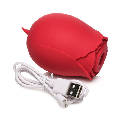 Red rose-shaped silicone personal massager with USB charging cable on white background.