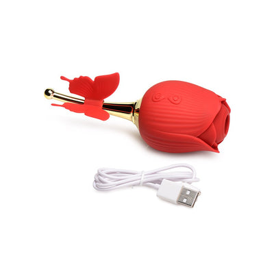 Red rose-shaped clit stimulator with golden stem and butterfly detail, shown with a USB charging cable on white background.