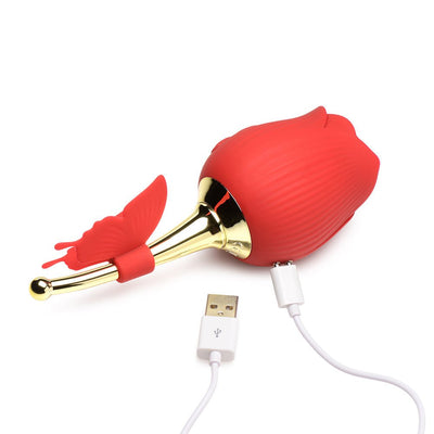 Red rose-shaped clitoral stimulator with gold stem, fluttering butterfly detail, and USB charging cable.
