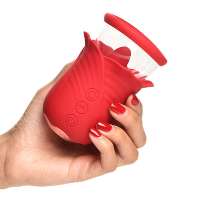 Hand holding a red silicone flower-shaped personal massager with control buttons and a clear suction cup top.
