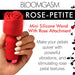 Hand holding a red mini silicone wand with a rose-shaped attachment, highlighting its textured petals and compact design.