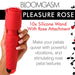 Hand holding a red silicone wand with a rose-shaped attachment and textured handle, featuring control buttons.