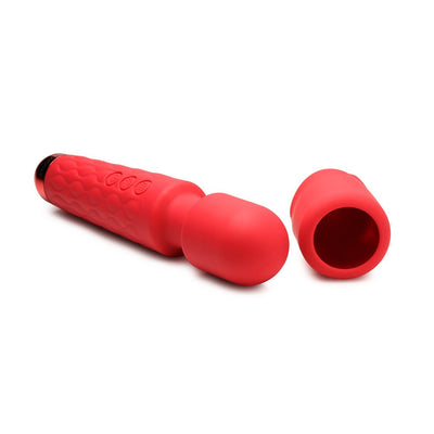 Red silicone wand massager with flexible head and removable rose-shaped attachment on white background.