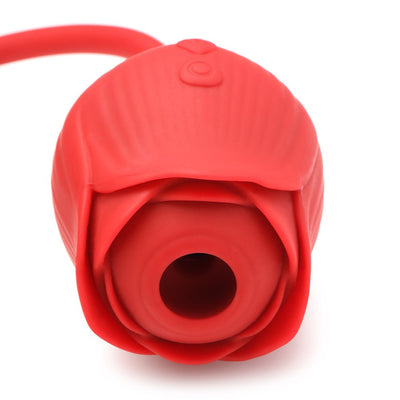 Close-up of a red silicone rose-shaped vibrator with a suction opening and control buttons on top.