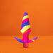 Colorful silicone vibrating plug with tapered tip and flared base against an orange background.