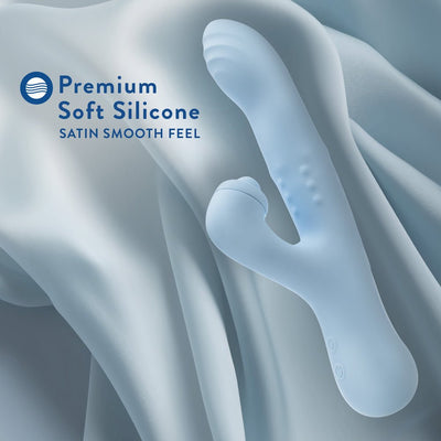 Light blue silicone rabbit vibrator with dual stimulation design and textured shaft, shown on soft fabric background.