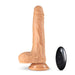 Realistic vanilla-colored silicone dildo with suction base and black wireless remote control on white background.
