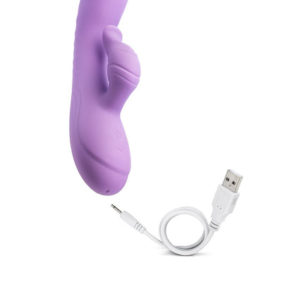 Purple silicone rabbit vibrator with curved design and USB charging cable on white background