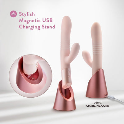 Blush Fraya Pink vibrator with dual stimulation, shown on stylish rose gold magnetic USB charging stand with USB-C cord.