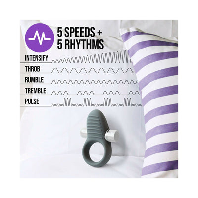 Slate gray silicone ring with removable bullet vibrator, shown with vibration pattern options and purple striped pillow background.
