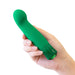 Hand holding a green, curved G-spot vibrator with a faceted gem-like base detail.