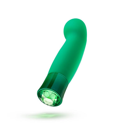 Emerald green curved G-spot vibrator with a faceted gem-like base and smooth silicone finish.