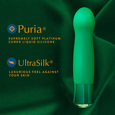 Emerald green G-spot vibrator on matching fabric highlighting Puria silicone and UltraSilk luxurious texture.