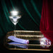 Lavender vibrator with faceted gem-like base on gold mirrored tray beside crystal accents and martini glass.
