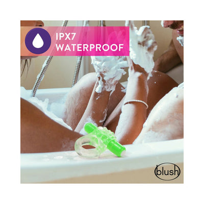 Green vibrating C-ring displayed on bathtub edge with couple enjoying a bubbly bath, highlighting waterproof feature.