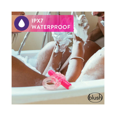 Pink textured vibrating C-ring displayed in a bathtub with a couple enjoying a bubble bath, highlighting its waterproof feature.