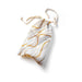 White cotton drawstring toy bag with gold abstract swirl pattern, soft texture, and natural cotton ties.