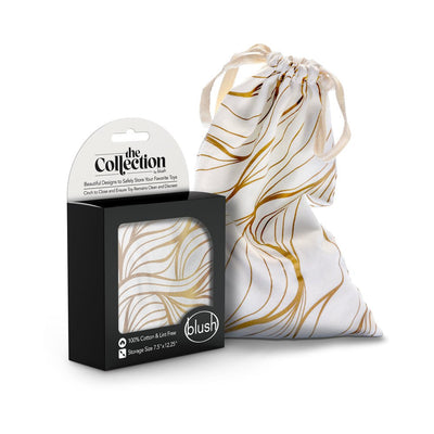 White cotton drawstring toy bag with gold abstract lines next to its black and white packaging box.