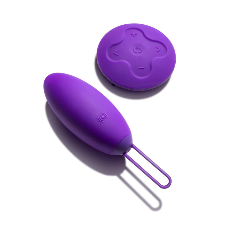 Purple vibrating egg with wireless remote control, smooth silicone finish, and easy-to-use buttons on a white background.