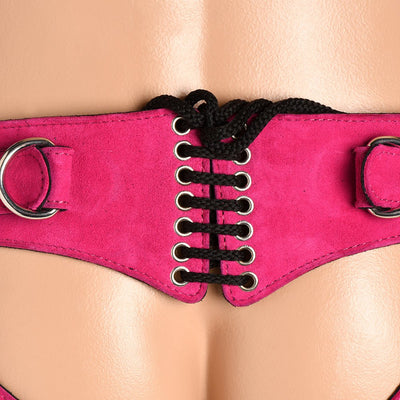 Close-up of pink leather corset harness with black laces and metal o-rings on hips, worn on a mannequin.