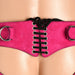 Close-up of pink leather corset harness with black laces and metal o-rings on hips, worn on a mannequin.