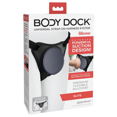 Body Dock Elite universal strap-on harness system with flexible silicone docking plate and adjustable nylon straps in packaging box.