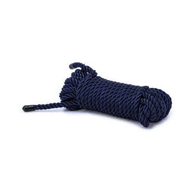 Coiled blue synthetic bondage rope with black capped ends on white background