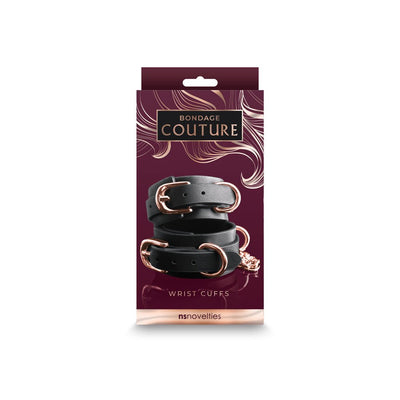 Black synthetic wrist cuffs with rose gold buckles and hardware, packaged in a stylish Bondage Couture box.