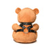 Light peach plush teddy bear wearing a black faux leather harness with metal O-ring and studs, shown from the back.