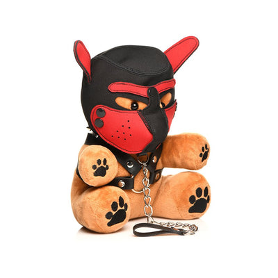 Plush light brown bear wearing a black and red puppy mask and faux leather harness with metal chain leash accessory.