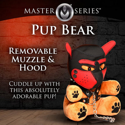 Plush pup bear with removable black and red muzzle hood and faux leather harness with chain leash on wooden floor background.