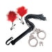 Set of black faux leather flogger, metal handcuffs with keys, and red feather-tipped nipple clamps on white background.
